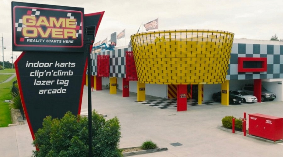 Game Over Gold Coast attraction building with vibrant yellow and red exterior, a top pick for indoor go-karting, laser tag, and climbing among the best things to do in Gold Coast.