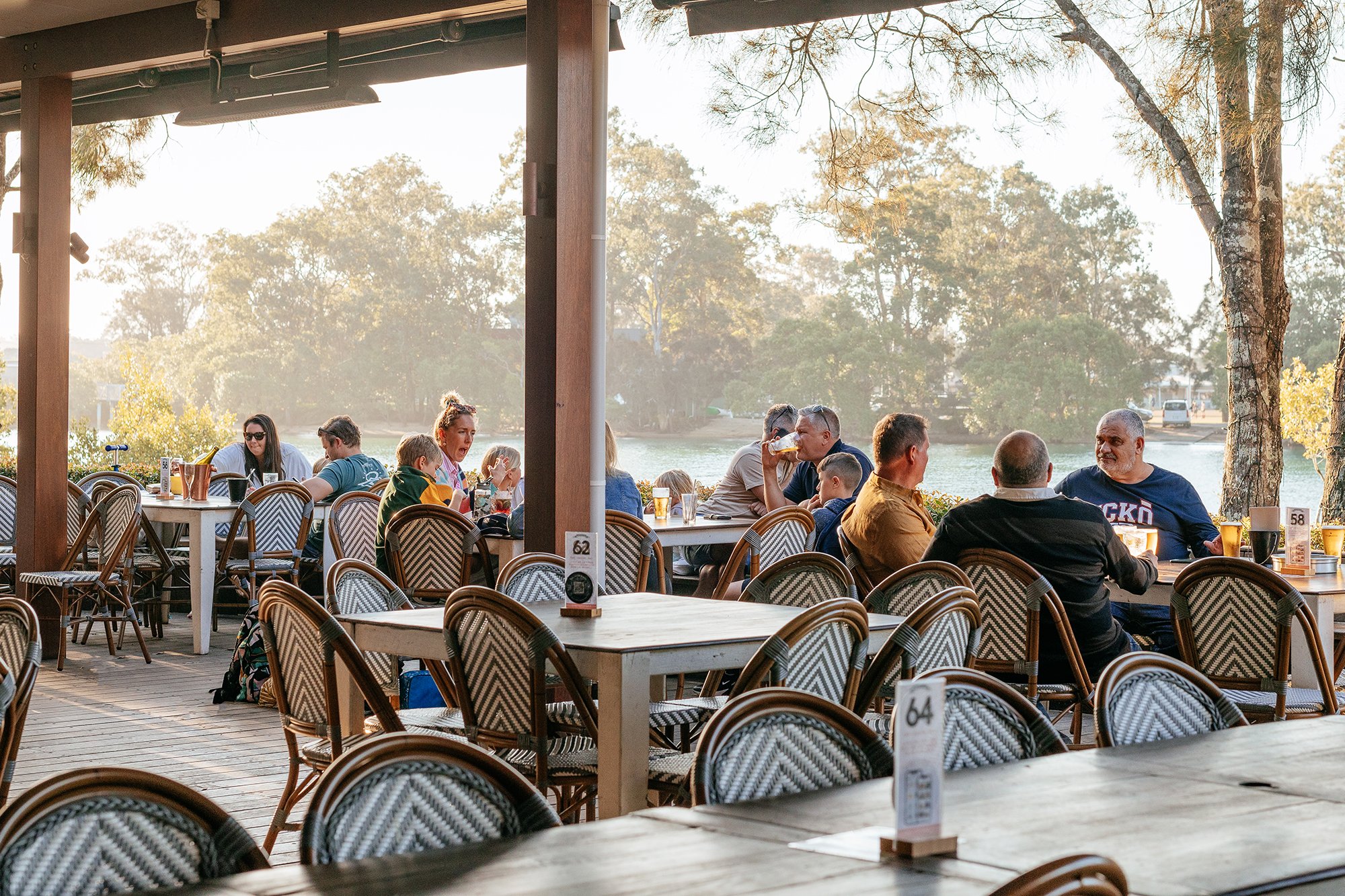 isle-of-palms-arrival-night-dinner Families dining on the creekside deck at Currumbin RSL near Elanora at golden hour