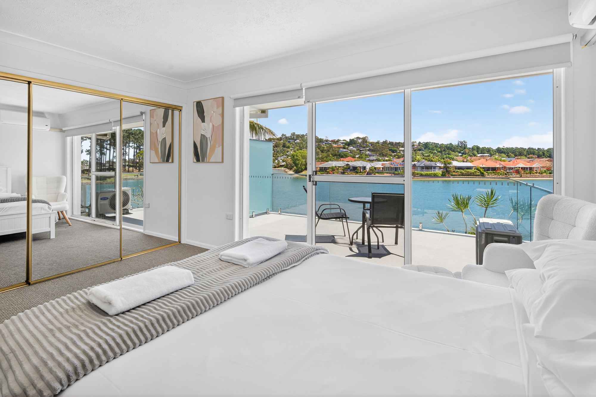 what-families-say-isle-of-palms Waterfront townhouse bedroom with a private balcony overlooking Pine Lake at Isle of Palms Resort Elanora